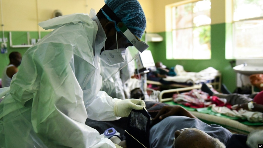 A health worker attends to a COVID-19 patient at Queen Elizabeth Central Hospital COVID-19 male ward in Blantyre, Malawi, Jan. 30, 2021