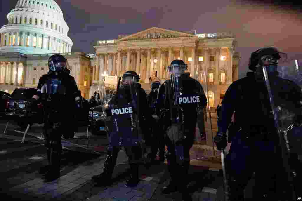 Authorities remove protesters from the U.S. Capitol, Jan. 6, 2021, in Washington. 