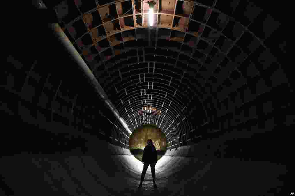 A woman takes a tour of the Bunker-703, a recently declassified nuclear-resistant bomb shelter built in 1961 at a depth of 43 meters (141 feet) for the Soviet Foreign Affairs Ministry archive, in Moscow, Russia.