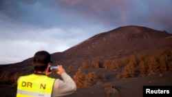 FILE - A drone pilot takes a picture of the mountain created by the eruption of the Cumbre Vieja volcano after of 89 days of its start, in the area of Las Manchas, in El Paso, on the Canary Island of La Palma, Spain, Dec. 17, 2021. 