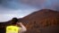FILE - A drone pilot takes a picture of the mountain created by the eruption of the Cumbre Vieja volcano after of 89 days of its start, in the area of Las Manchas, in El Paso, on the Canary Island of La Palma, Spain, Dec. 17, 2021. 
