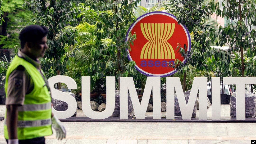 A security guard walks past the ASEAN logo at the 27th Association of Southeast Asian Nations (ASEAN) summit in Kuala Lumpur, Malaysia, on Nov. 19, 2015. The ASEAN summit and relating meetings are held in Malaysia on Nov. 18-22. 
