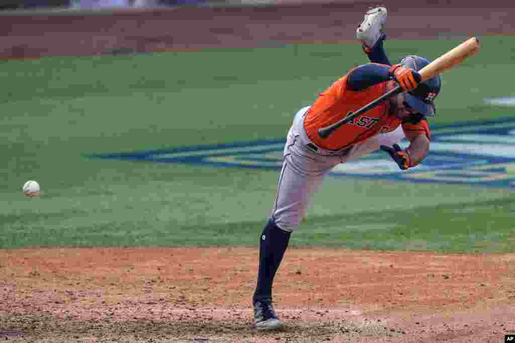 Houston Astros' Jose Altuve is hit by a pitch during the eighth inning of Game 1 of a baseball American League Division Series against the Oakland Athletics in Los Angeles, California, Oct. 5, 2020.