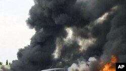 Image taken from APTN footage shows smoke bellowing after an explosion at the police headquarters, in Abuja, June 16, 2011