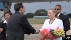 US Secretary of State Hillary Clinton shakes hands with US Ambassador to Cambodia William E. Todd upon arriving in Phnom Penh on Wednesday.