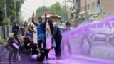 Kashmiri government employees demonstrate as riot police spray purple-dyed water during a protest march in Srinagar. Indian police detained dozens of government employees as they tried to stage a protest march demanding the regularisation of contractual jobs and an increase in salary.