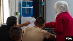 Teenage boys of different nationalities were taken from al-Roj Camp and al-Hol Camp study math in al-Houri Rehabilitation Center in Northeast Syria on Oct. 9, 2024. (Yan Boechat/VOA)