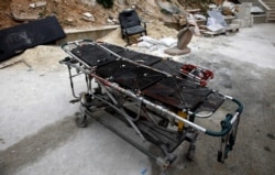A stretcher covered in blood is left in front of a hospital in Idlib province, Syria, Feb. 28, 2020.