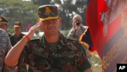 Lt. Gen. Hun Manet, son of Cambodian Prime Minister Hun Sen and deputy commander of the Royal Cambodian Army and commander of the National Counter Terror Special Force, walks through honorary guards as his arrives for presiding over a U.S.-backed peacekeeping exercise dubbed "Angkor Sentinel 2014" at the Cambodian tank command headquarters in Kampong Speu province, 60 kilometers (37 miles) west of Phnom Penh, Cambodia, Monday, April 21, 2014. (AP Photo/Heng Sinith)