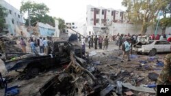 Les secouristes se tiennent près des épaves de véhicules après l'attentat de la veille,à Mogadiscio, Somalie, 29 octobre 2017,