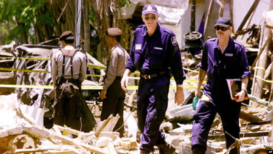Dalam foto tertanggal 17/10/2002 ini polisi Indonesia dan tim forensik Australia melakukan pemeriksaan di lokasi ledakan di Kuta, Bali , setelah terjadi serangan bom pada 12/10/2002. 