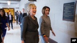 House Minority Leader Nancy Pelosi of California escorts Democratic presidential candidate Hillary Clinton after a House Democratic caucus meeting on Capitol Hill in Washington, June 22, 2016.