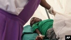 A patient suffering from HIV is taken to a local hospital in Harare, January 31, 2012. 