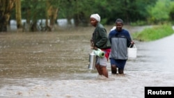 Residents affected after a seasonal river burst its banks following heavy rainfall in Kitengela municipality of Kajiado County