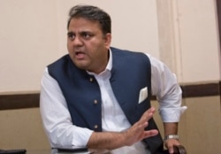 FILE - Pakistani Information Minister Fawad Chaudhry speaks to The Associated Press, in Islamabad.