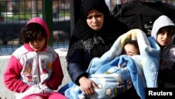 FILE - Migrants are pictured at a Turkish coastguard station in the Turkish coastal town of Dikili, after a failed attempt at crossing to the Greek island of Lesbos, April 6, 2016.