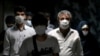 People wearing protective face masks to help prevent the spread of the coronavirus walk in a metro station, in Tehran, Iran, Wednesday, July 8, 2020. (AP Photo/Ebrahim Noroozi)