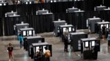 People cast their ballots during early voting for the upcoming presidential elections inside of The Atlanta Hawks' State Farm Arena in Atlanta, Georgia, U.S., October 12, 2020.