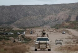 Mexican military members patrol in La Mora, Sonora state, Mexico, the community where a funeral was held for Dawna Ray Langford, 43, and her sons Trevor, 11, and Rogan, 2, who were killed by drug cartel gunmen, Nov. 7, 2019.
