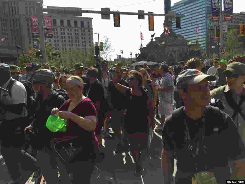 Black Lives Matter activists chanted as they walked away from Public Square, while police officers on bicycles rode in a line next to them, trying to keep them on the sidewalk and in one lane of traffic, in Cleveland, July 19, 2016.