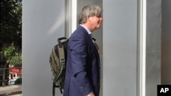 British BBC correspondent Jonathan Head enters the provincial court at the start of his trial, Aug. 23, 2017, on the southern island of Phuket, Thailand.