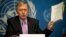 Michael Kirby, chairperson of the commission of Inquiry on Human Rights in the Democratic People's Republic of Korea, shows the commission's report during a press conference at the United Nations in Geneva, Switzerland, Feb. 17, 2014.