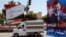 A vehicle drives past campaign posters of the June 3 presidential election in Damascus, Syria, May 12, 2014. 