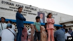 (FILE) Syrians fleeing the war in Lebanon, arrive at the Syrian-Lebanese border crossing in Jdeidet Yabous, Syria, Wednesday, Sept. 25, 2024.