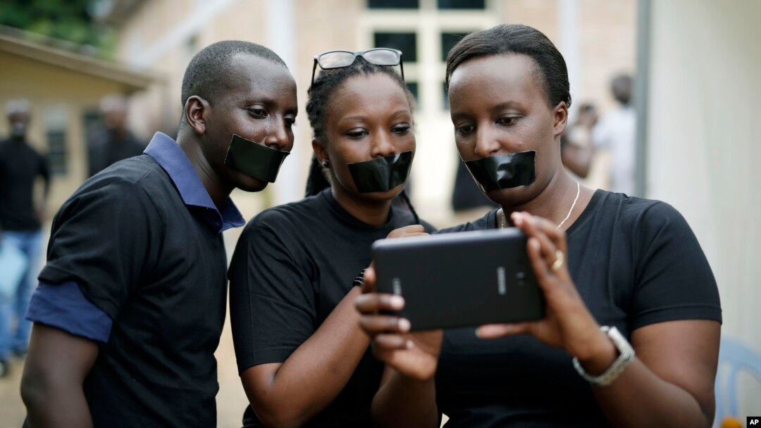 Journalists with tape on their mouths gather on the occasion of World Press Freedom Day, Bujumbura, Burundi, May 3, 2015. 