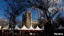 A Christmas market is seen on Dec. 4, 2024, along the banks of the River Seine in Paris near the Notre Dame Cathedral, which was ravaged by a fire in 2019.