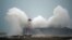 Waves crash over Newhaven Lighthouse on the south coast of England on February 9, 2020, as Storm Ciara swept over the country. 