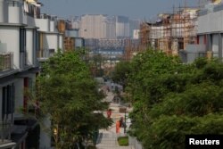 Phase One of Novotown is under construction at Hengqin Island, adjacent to Macau (background), China, Sept. 13, 2017.