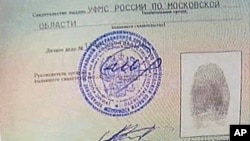 An image taken from AP Television shows a copy of a temporary document that allows Edward Snowden to cross the border into Russia, held by Russian lawyer Anatoly Kucherena visiting Snowden at Sheremetyevo airport outside Moscow, August 1, 2013. 