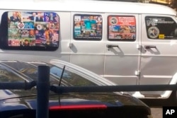 This Nov. 1, 2017, photo shows a van with windows covered with an assortment of stickers in Well, Florida. Federal authorities took Cesar Sayoc into custody on Oct. 26, 2018, and confiscated his van, which appears to be the same one.