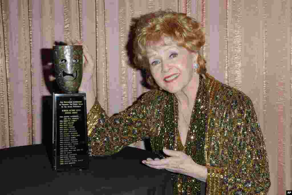 អ្នកស្រី Debbie Reynolds ដែល​បាន​ឈ្នះ​ពាន​រង្វាន់ស្នាដៃ​ពេញ​មួយ​ជីវិត​ ​​SAG កំពុង​នៅ​ក្រោយ​ឆាក​ក្នុង​កម្មវិធី​ប្រគល់ពាន​រង្វាន់​ Screen Actors Guild ទី​២១ ប្រចាំឆ្នាំនៅ​សាល​ Shrine Auditorium កាលពី​ថ្ងៃទី ២៥ មករា ២០១៥ ទីក្រុង Los Angeles។