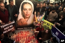 FILE - Supporters of Pakistan's slain leader Benazir Bhutto take part in a memorial in Lahore, Pakistan, Dec. 27, 2015.