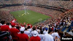 FILE - Fans watch the opening ceremonies for the first World Cup soccer game ever held in an indoor stadium June 18 at the Pontiac Silverdome, in Michigan.