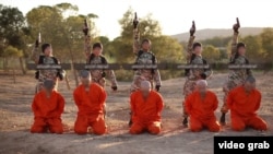 A screenshot from an Islamic State propaganda video that purports to show young boys executing Kurdish fighters.