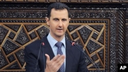 In this photo released by the Syrian official news agency SANA, shows Syrian President Bashar Assad, as he delivers a speech at the parliament in Damascus, June 3, 2012.