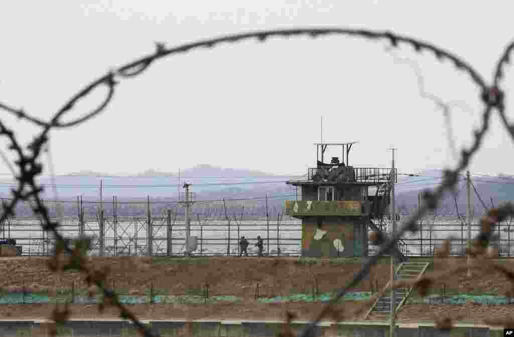 South Korean army soldiers patrol along the barbed-wire fence in Paju, near the border with North Korea, in South Korea. North Korea fired a suspected ballistic missile into the sea, the South Korean and Japanese militaries said.