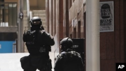 Police anti-terror forces are seen dispatched in Martin Place, in the central business district of Sydney, Australia, Dec. 15, 2014.