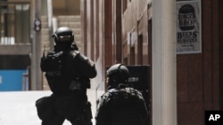 FILE - Police anti-terror forces are seen dispatched in Martin Place in the central business district of Sydney, Australia, Dec. 15, 2014.