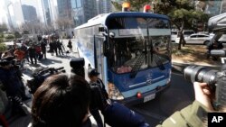 A bus carrying Cho Hyun-ah, former vice president of Korean Air Lines Co., arrives for her trial at the Seoul Western District Court in Seoul, South Korea, Monday, Feb. 2, 2015.