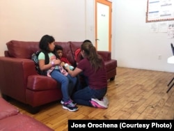 Yeni Gonzalez is reunited with her three children at the Cayuga Care Center in New York, July 3, 2018.