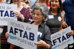 FILE - Supporters gather to listen to former U.S. Rep. Gabby Giffords and Hamilton County Clerk of Courts Aftab Pureval speak during the "Women for Aftab" advocacy group kickoff event in support of Pureval's 1st House District challenge to veteran Republican Rep. Steve Chabot, June 13, 2018, in Cincinnati.