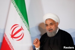 FILE - Iranian President Hassan Rouhani addresses the Innovation and Industry Forum during an official visit in Bern, Switzerland, July 3, 2018.