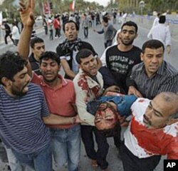 Bahrainis carry a wounded anti-government protester in Manama during the first wave of the crackdown, February 18, 2011