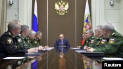Russian President Vladimir Putin, center, chairs a meeting on the defense industry at the Bocharov Ruchei state residence in Sochi, Russia, Nov. 10, 2015. 