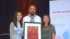 Many Uch, middle, receives an Individual Changemaker award from SEARAC's representatives at Renaissance Hotel, Washington DC,​ October 13, 2017. (Hong Chenda/VOA)