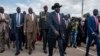 South Sudan's President Salva Kiir, center, arrives back in the country from peace talks in Addis Ababa, at the airport in Juba, South Sudan, June 22, 2018.